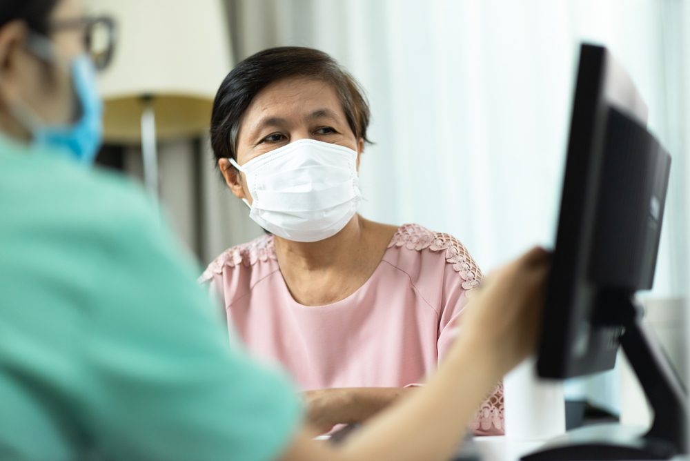 Female patient is shown screen by doctor. Image courtesy of by eggeegg via Shutterstock